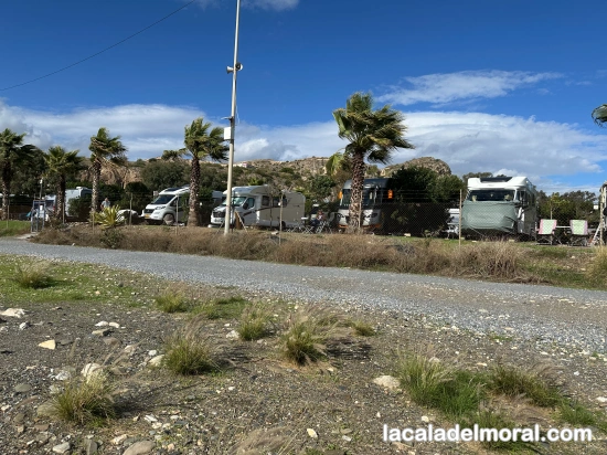 acceso directo a la playa desde el Área Málaga Beach para autocaravanas, con vista del sendero litoral y entorno natural.